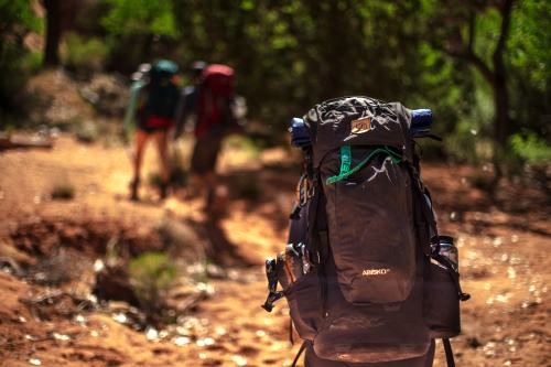 family walking with their bug-out backpacks by patrick-hendry-lsJsaERGu4c-unsplash